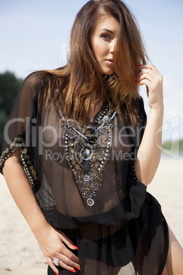 beautiful brunette woman in black transparent blouse
