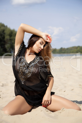 beautiful brunette woman in black transparent blouse