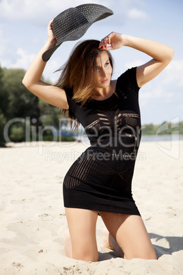 beautiful brunette woman in black dress bikini