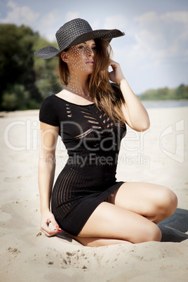 beautiful brunette woman in black dress bikini