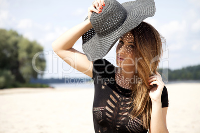 beautiful brunette woman in black dress bikini