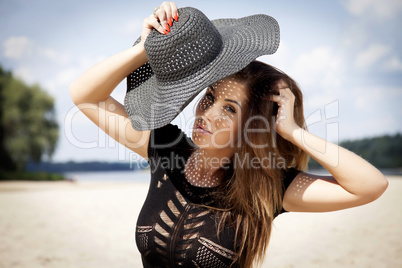 beautiful brunette woman in black dress bikini