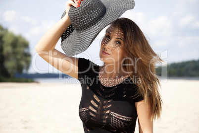 beautiful brunette woman in black dress bikini