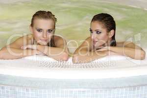 Two young beautiful girls in jacuzzi