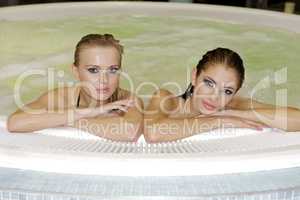 Two young beautiful girls in jacuzzi