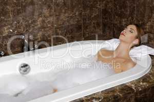 Woman in bath relaxing. Closeup of young woman in bathtub bathin