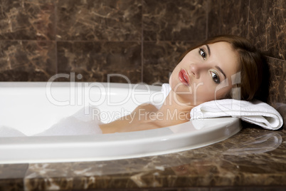 Woman in bath relaxing. Closeup of young woman in bathtub bathin