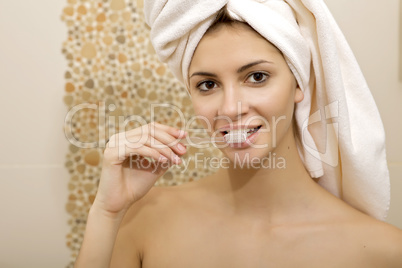 pretty female brushing her teeth