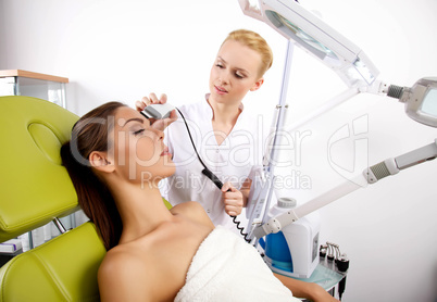 Young woman receiving laser therapy