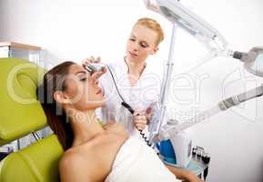 Young woman receiving laser therapy