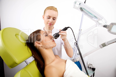 Young woman receiving laser therapy