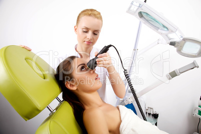 Young woman receiving laser therapy