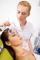 young woman getting beauty skin mask treatment on her face with