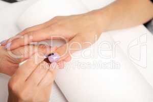 Manicure - Beautiful manicured woman's nails with violet nail po