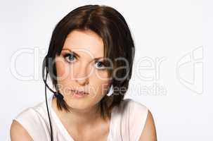 beautiful girl with dark hair with headphones and microphone wearing white blouse