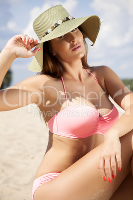 beautiful brunette woman in pink bikini