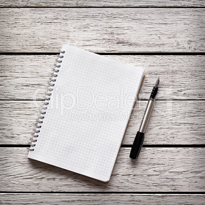 Blank notepad with a pen