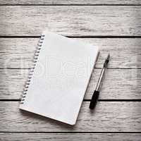 Blank notepad with a pen