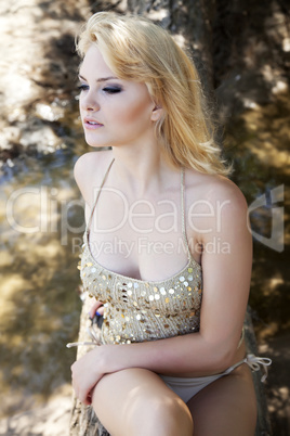 Fashion portrait of young sensual woman in garden