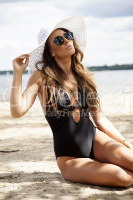 beautiful brunette woman in black dress bikini