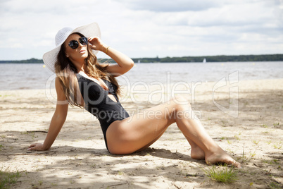 beautiful brunette woman in black dress bikini