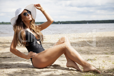 beautiful brunette woman in black dress bikini