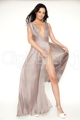 Young slim sexy woman in brown dress isolaten on white backgroun