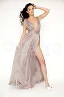 Young slim sexy woman in brown dress isolaten on white backgroun