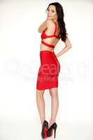 Young slim sexy woman in red dress isolaten on white background