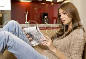 mid adult woman drinking coffee and reading news