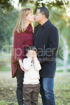 Mix Race Couple Kissing As Young Son Hides His Eyes