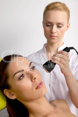 Young woman receiving laser therapy