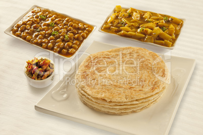 Puri paratha with chickpeas potato curry and pickels