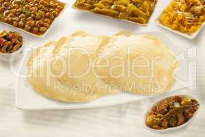 Puri paratha with chickpeas potato curry and sweet halwa and pic