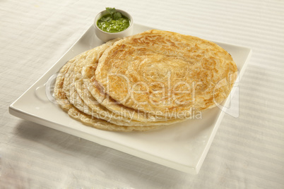 Plain paratha puri served with freshly diced corriander in green