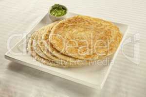 Plain paratha puri served with freshly diced corriander in green