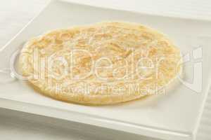Golden fried paratha served on a hot plate