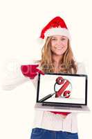 Composite image of festive blonde pointing to laptop