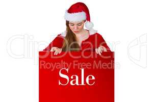 Composite image of pretty girl in santa costume showing card