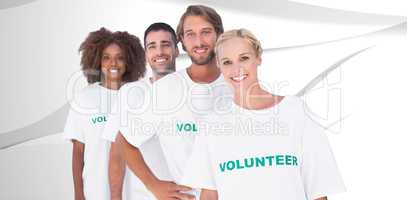 Composite image of smiling volunteer group