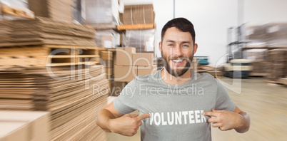 Composite image of man showing volunteer text on tshirt