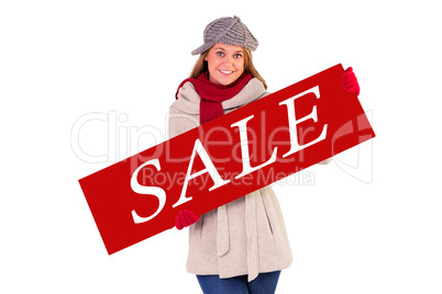 Composite image of happy blonde in winter clothes showing card