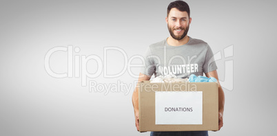 Composite image of portrait of man holding clothes donation box Composite image of portrait of man holding clothes donation box
