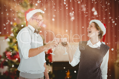 Composite image of happy geeky hipster couple drinking red wine