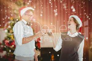 Composite image of happy geeky hipster couple drinking red wine