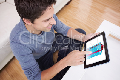 Composite image of overhead view of man using digital tablet in