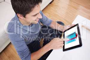 Composite image of overhead view of man using digital tablet in