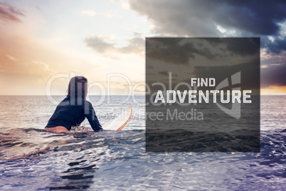 Composite image of rear view of a woman sitting on surfboard in water