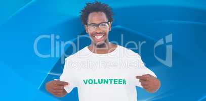 Composite image of handsome man pointing to his volunteer tshirt