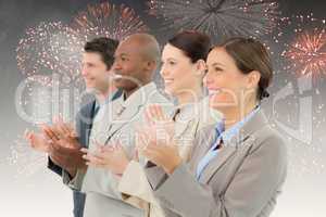 Composite image of side view of clapping sales team standing tog